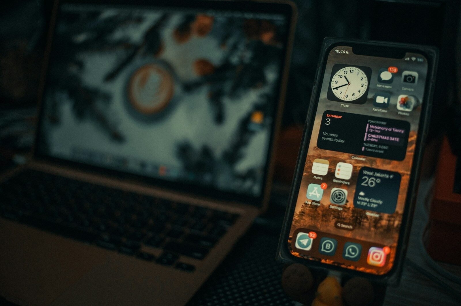 a cell phone next to a laptop